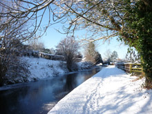 The canal in winter with the clear blue sky reflected in the water